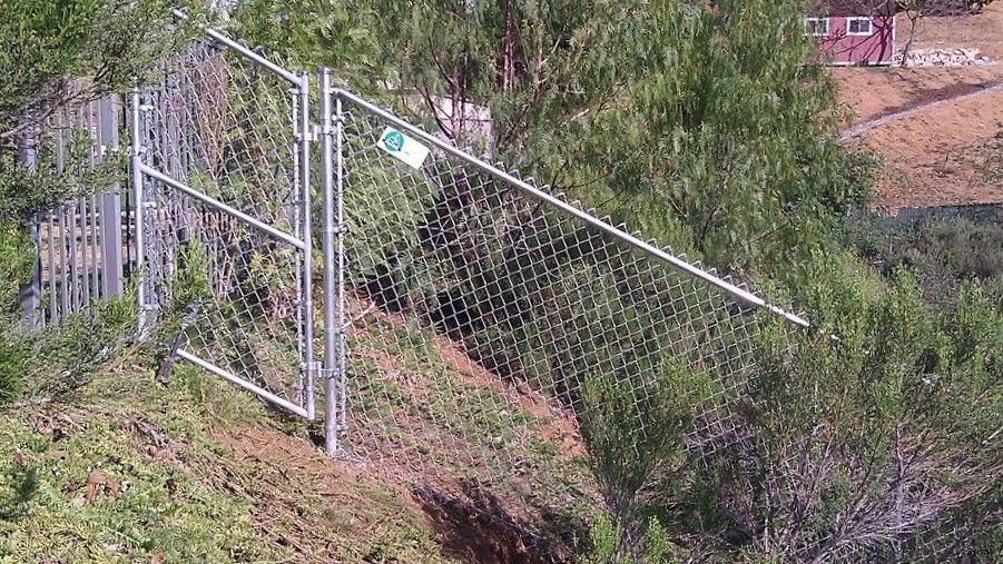 Chain link fence and gate on a slope
