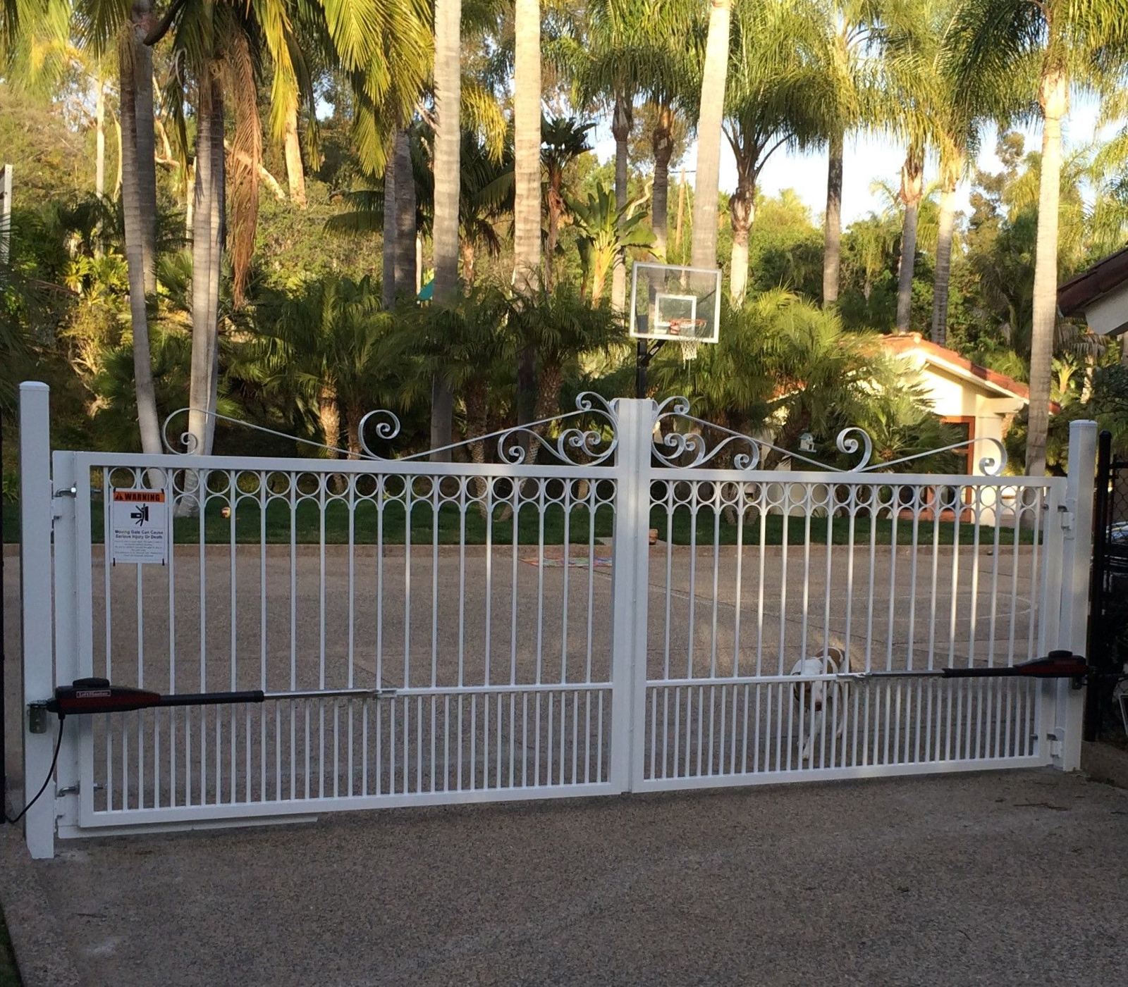 Ornamental metal driveway gate with automatic operators