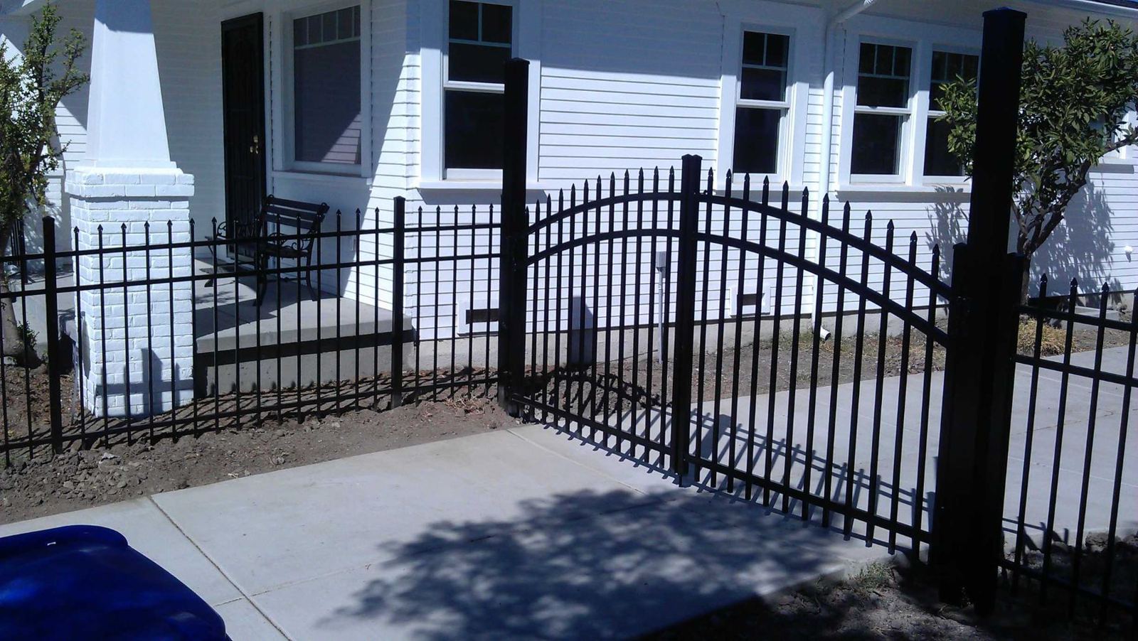 Ornamental iron fence with arched walk-through gate